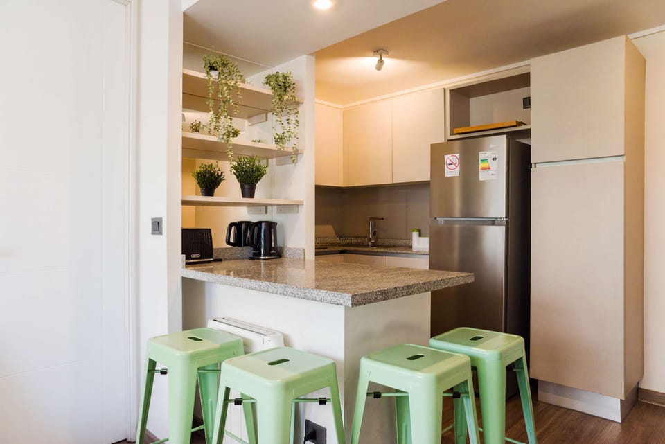 Chic and cozy kitchen with modern amenities and stylish seating, perfect for enjoying a meal or a quick snack.