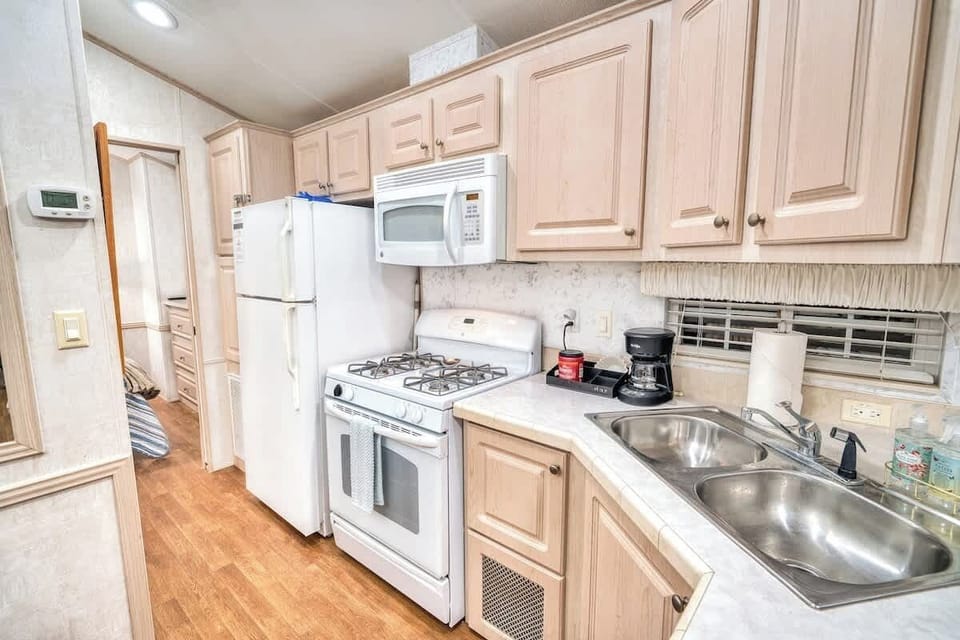 Full size fridge, stove and oven along with a double sink for your convenience.