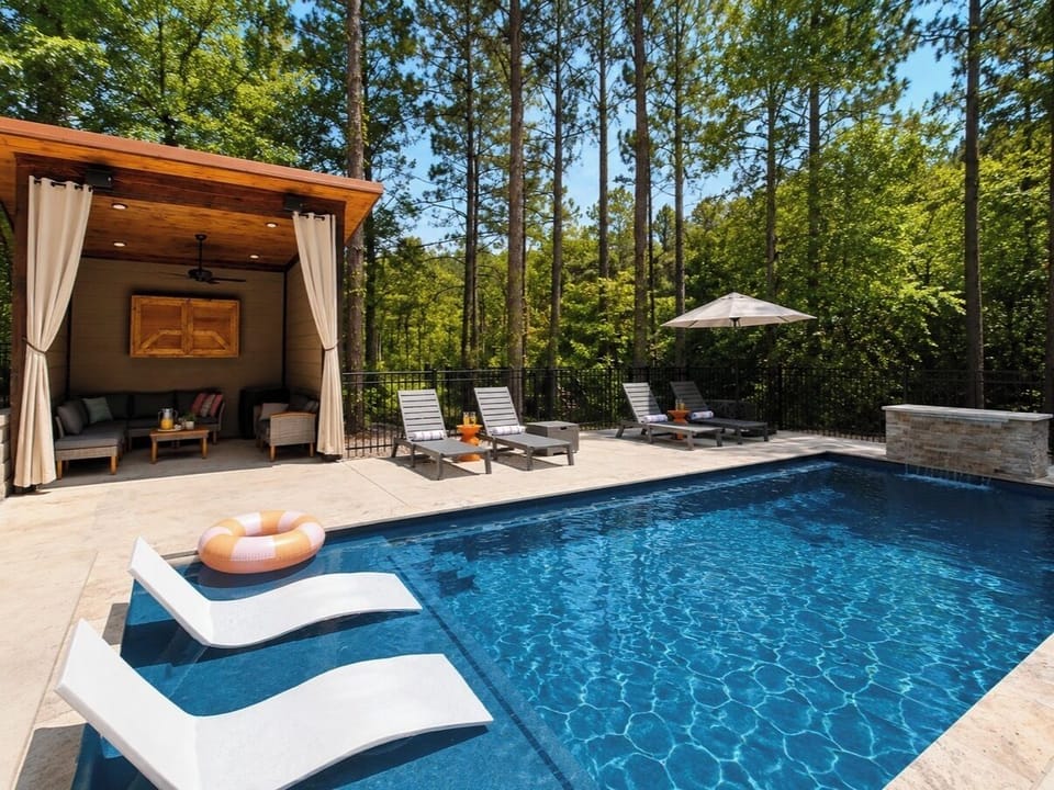 NEW! Resort style heated pool surrounded by towering pines with a spacious tanning ledge, luxury in pool loungers, private cabana lounge, and plenty of space to relax after a day exploring Broken Bow.