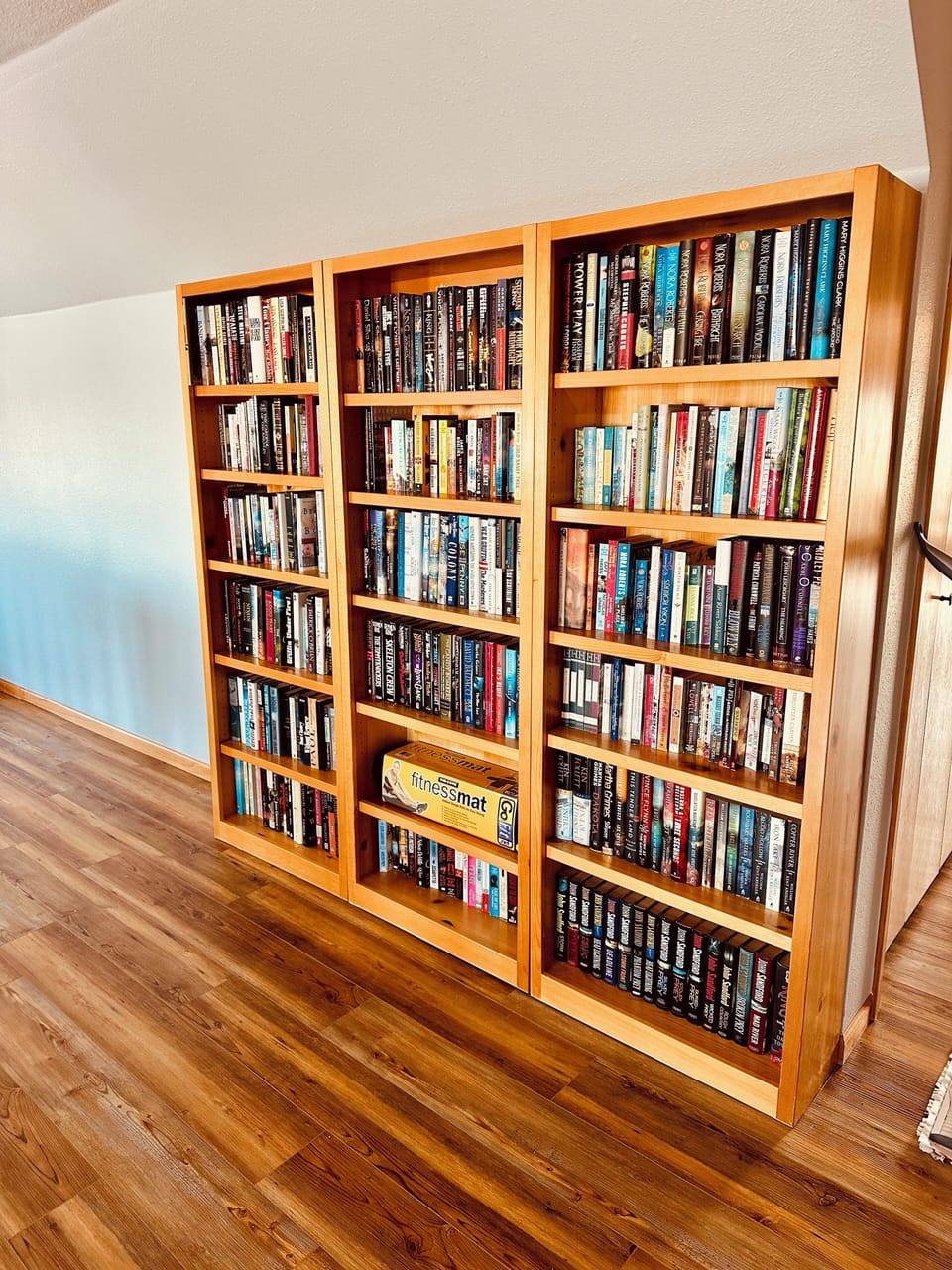 Tucked above it all, the loft is a peaceful reading nook with a book for everyone—perfect for rainy days, lazy mornings, or winding down after the lake.