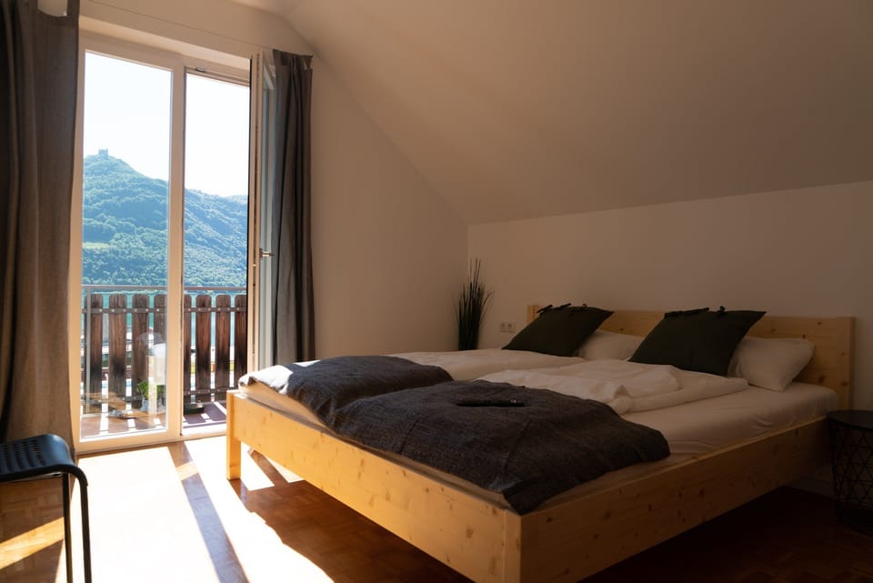 Sleeping area with balcony access and lake view