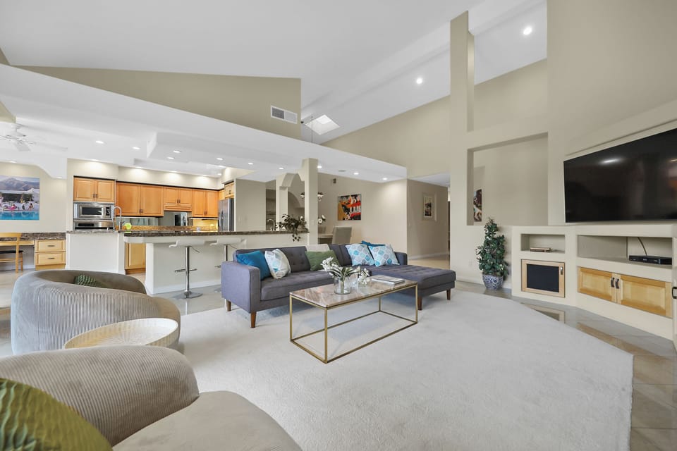 View of open living room, bar, and kitchen