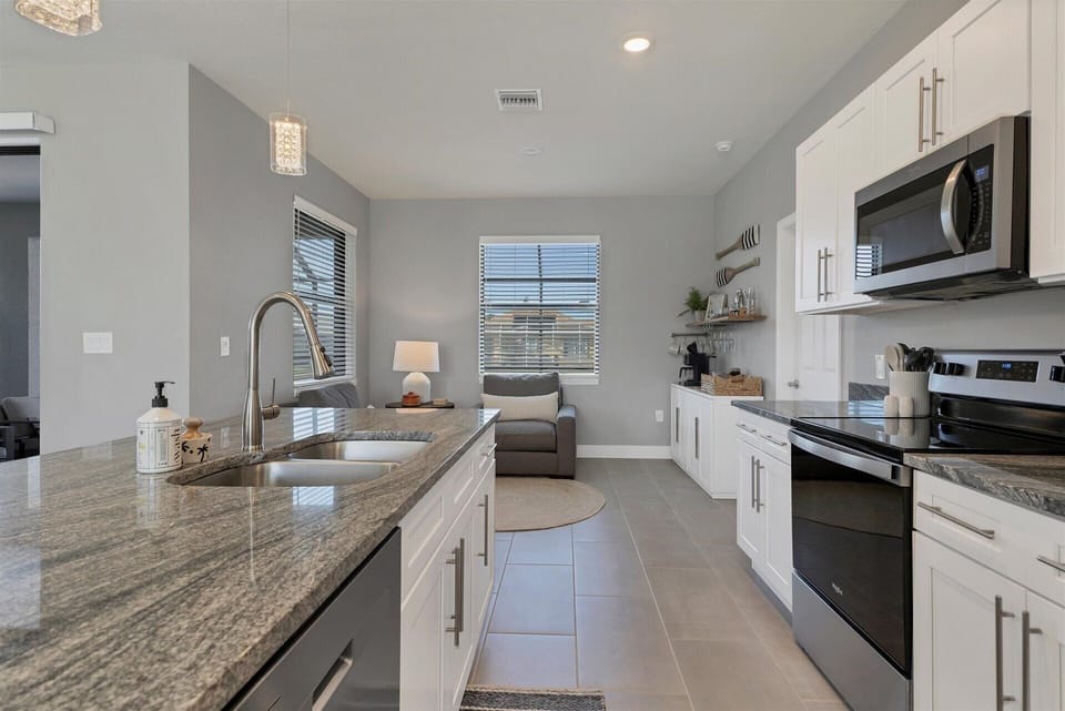 Fully equipped kitchen overlooking living room and dining area