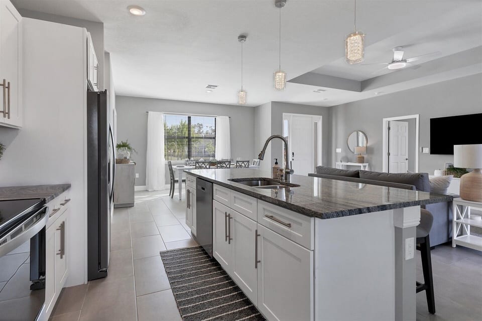 Fully equipped kitchen overlooking living room and dining area
