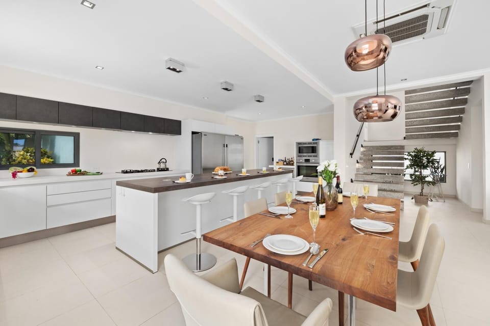 Gather around the spacious dining area, perfect for enjoying meals with family and friends in a warm, inviting atmosphere.