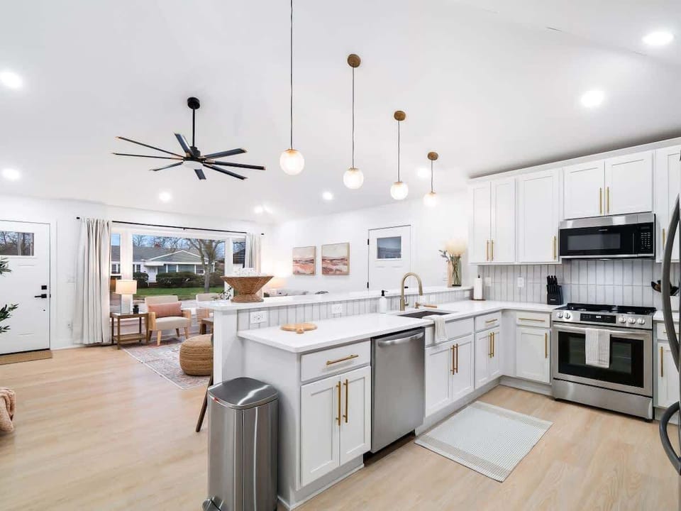 Light-filled kitchen w/ island seating & bright finishes for easy cooking