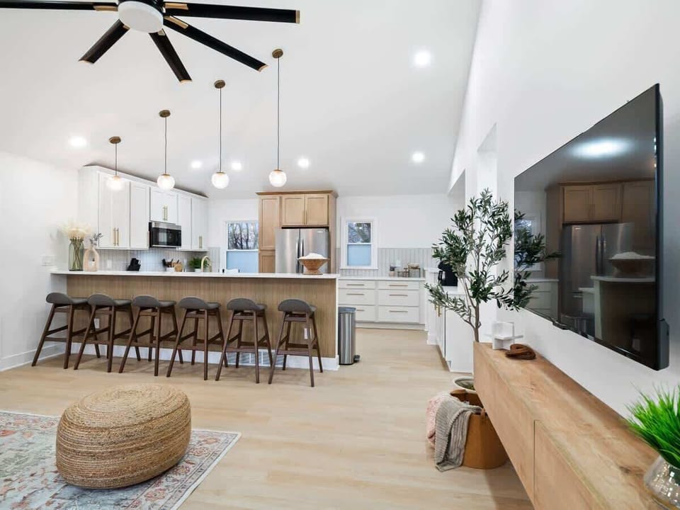Bright kitchen w/ long island, bar seating & sleek finishes