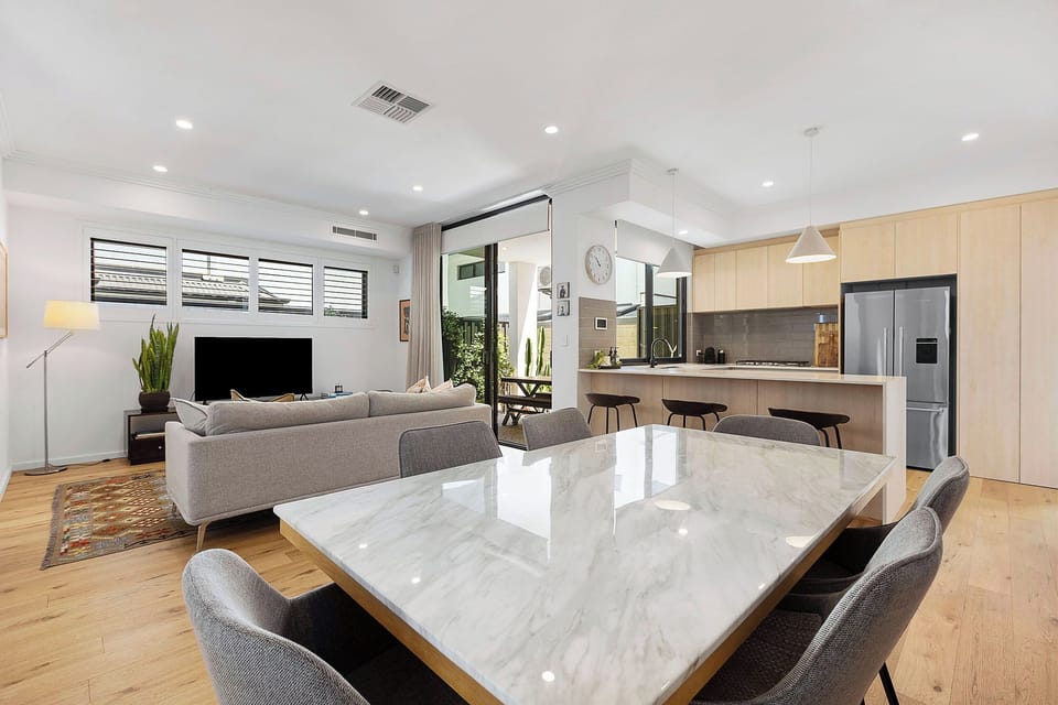 Large dining table with open plan living and kitchen