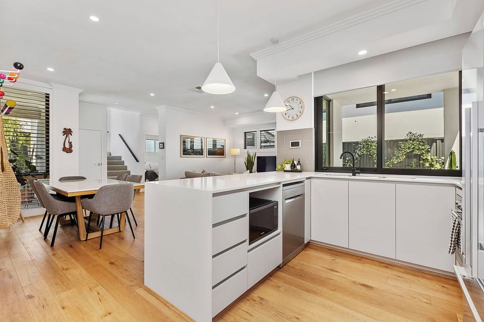 Kitchen located downstairs with dishwasher, fridge, microwave, toaster, kettle and double sink