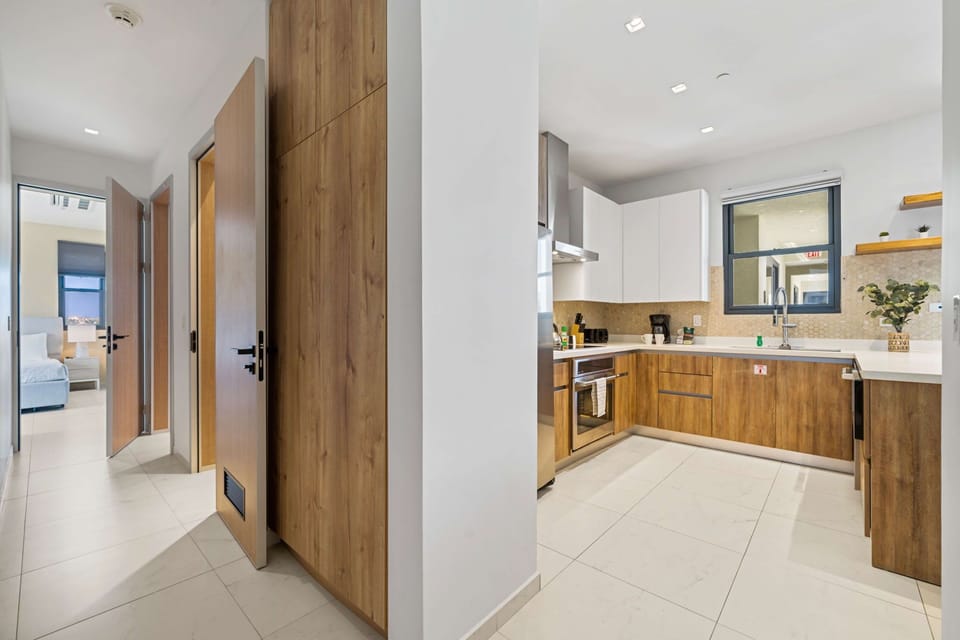 - Seamless flow and modern design, this layout connects the sleek kitchen with the rest of the home - Warm wood finishes complement bright spaces for a clean and stylish look - Perfect for maintaining connection while preparing meals or relaxing