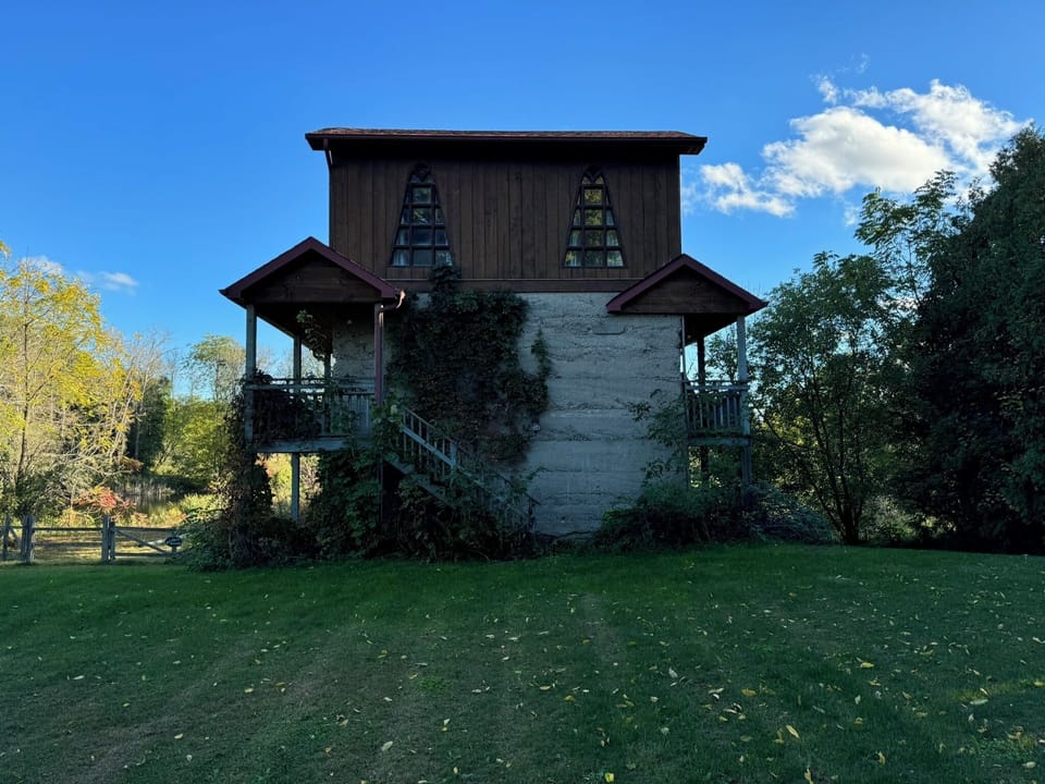 View from Parking, Main Entrance up The Stairs located off the wrap around deck.