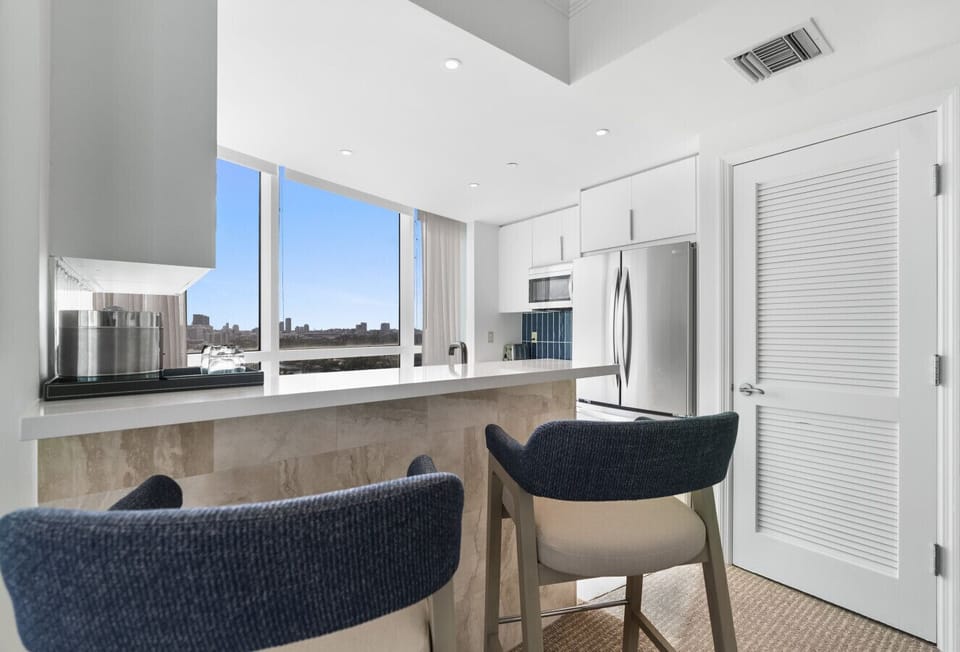 Countertop with barstools overlooking South Beach - There is a Full Washer and Dryer in the closet