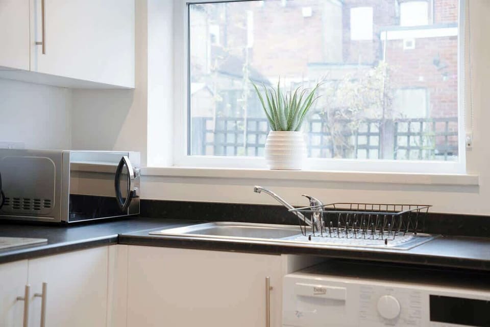 Kitchen oasis equipped with all essentials, including a washer & dryer, oven, fridge and full cookware set.