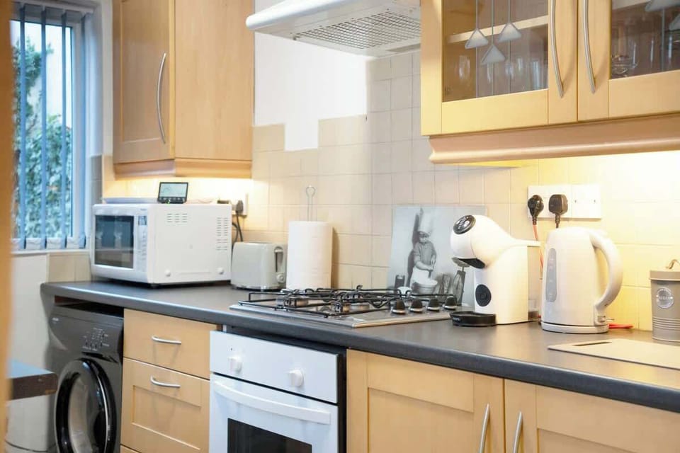 Kitchen equipped with all essentials, including a washer & dryer, oven, fridge and full cookware set.