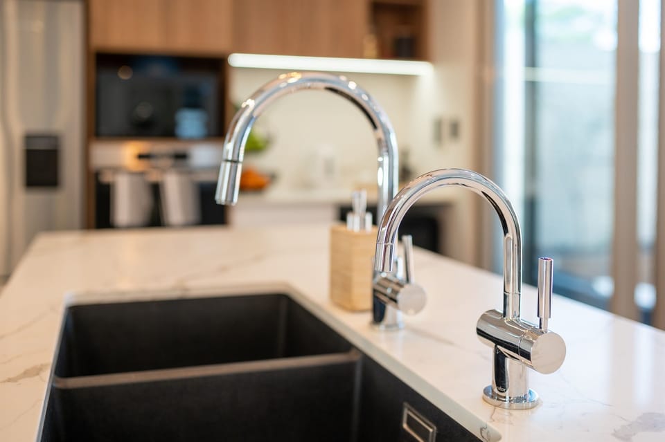 The sink in our kitchen island with filtered water.