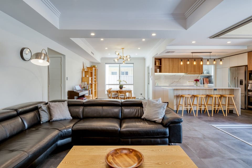 An open plan living room flows to the kitchen and dining area 