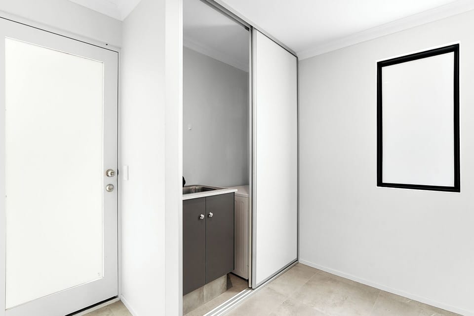 Laundry area: washing machine and basin located downstairs