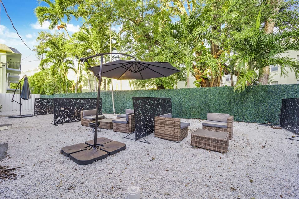 Outdoor patio with chairs, gravel ground, and surrounding greenery