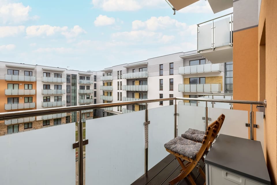 A private balcony with deck chairs and a small table, ideal for morning coffee.