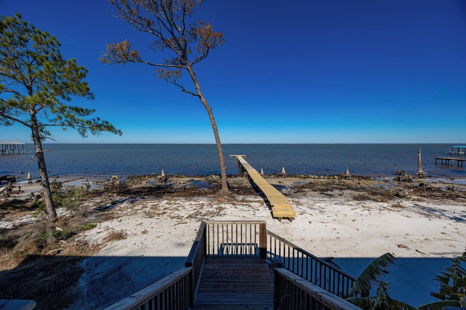 Have your own private oasis with stunning bay views and a private dock for relaxing days by the water at this serene getaway