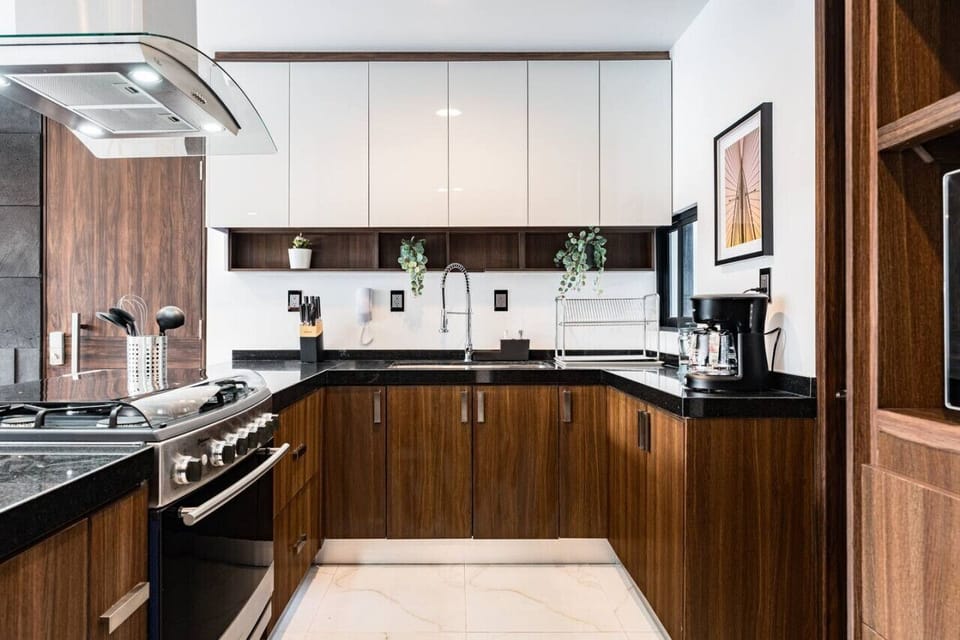 Prepare gourmet meals in the modern kitchen with sleek wooden cabinetry