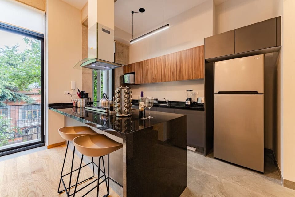 Gourmet kitchen with bar seating and stylish decor for group gatherings.