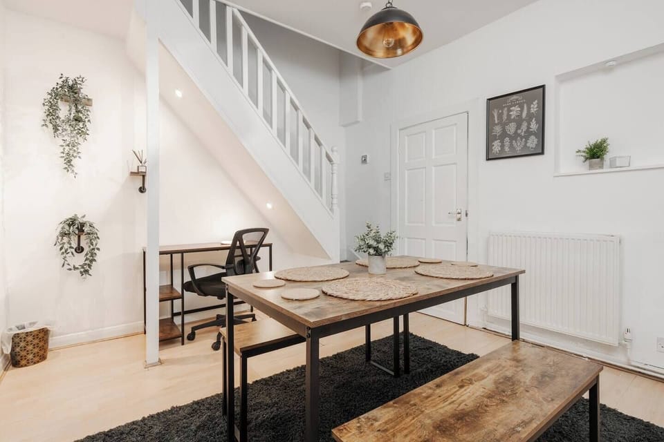 A versatile dining area with a spacious table for shared meals, plus a well-lit workspace so you can stay connected and work comfortably during your stay