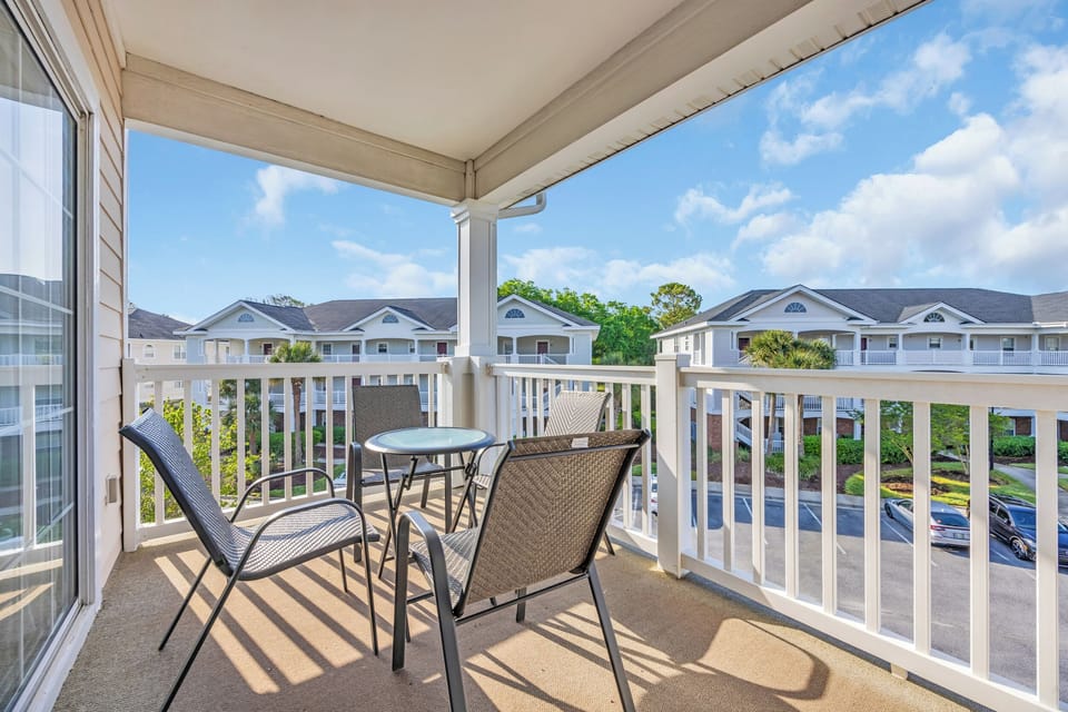 Relax and catch some fresh air on the private balcony after a day at the beach.