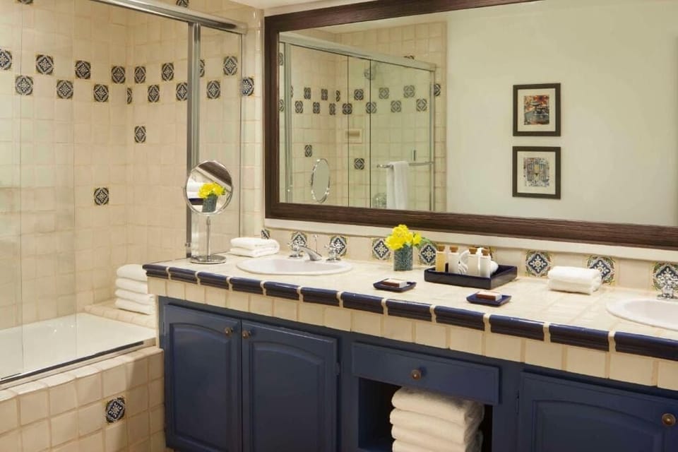 Refresh in a roomy bath with double sinks and plush towels.