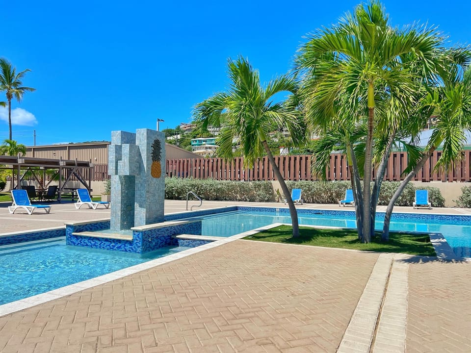 Surrounded by tropical greenery, the pool offers a relaxing getaway.