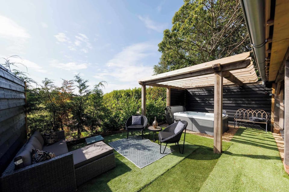 The superb outdoor space has plenty of places to sit. Not to mention the hot tub!