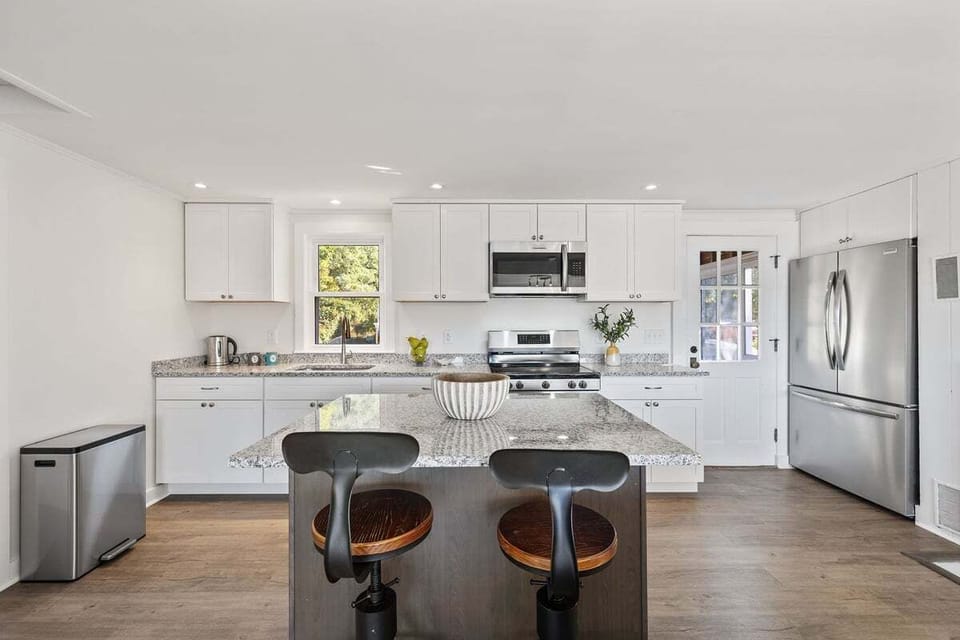 Updated kitchen with granite countertops and stainless steel appliances