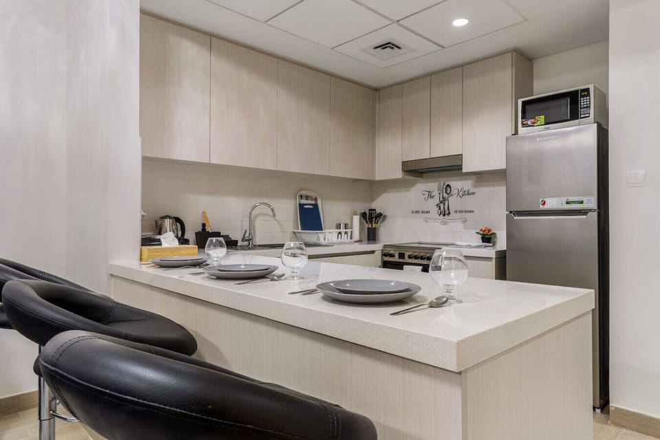 Kitchen: Stylish space with modern appliances, perfect for culinary adventures in Abu Dhabi!