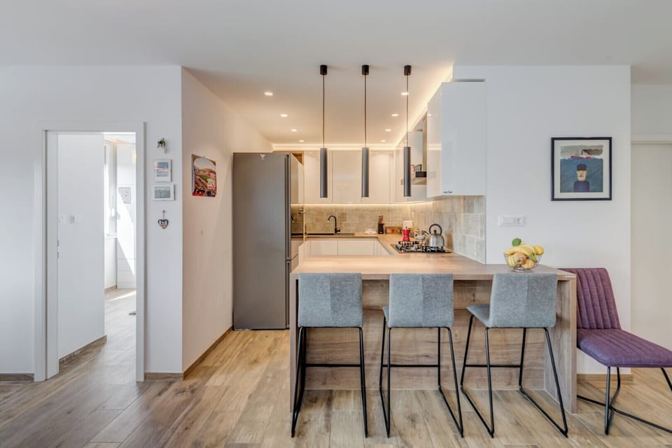 A sleek and modern kitchen and a stylish breakfast bar