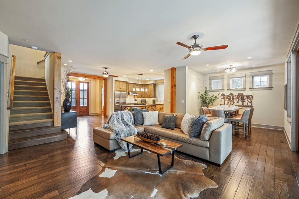 Warmth and elegance: gas fireplace, leather sectional, and views.