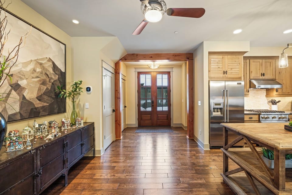 Welcoming entry opens to a chef’s kitchen with premium appliances and artisan woodwork.