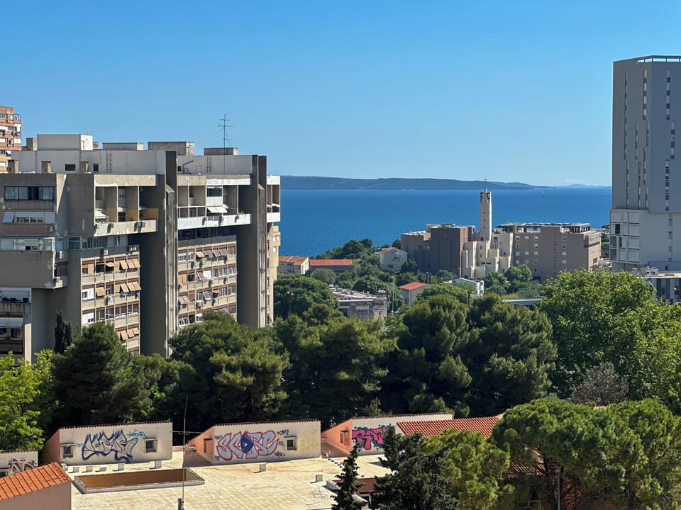 View from the apartment overlooking the city, sea, and surrounding nature.
