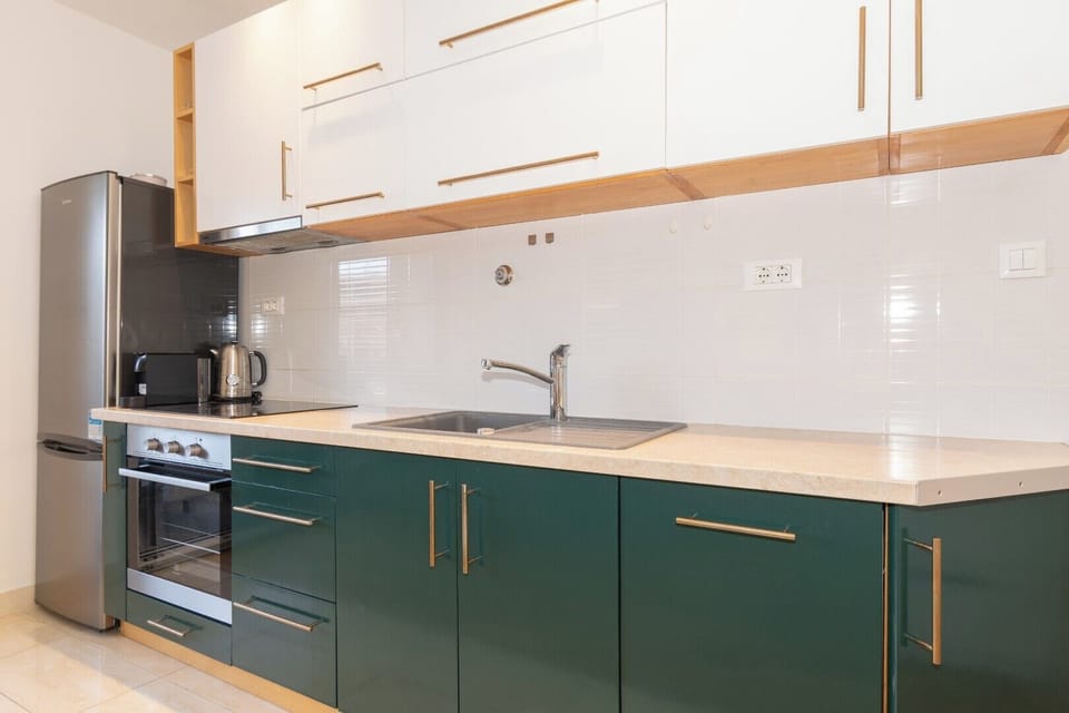 Elegant kitchen with golden accents, warm tones, and a refined style.
