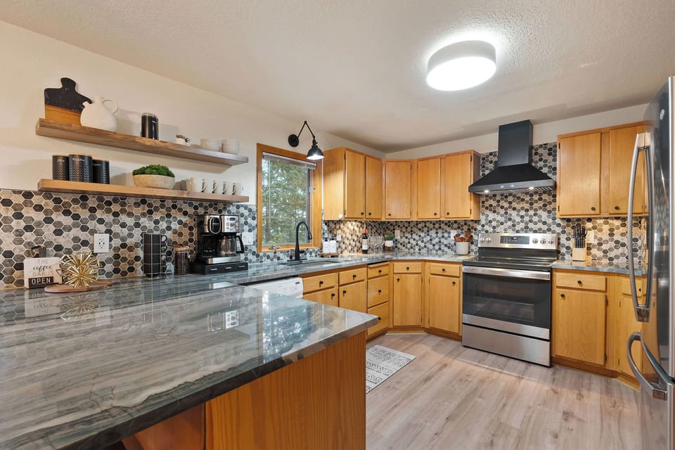 Beautiful quartzite countertops in the kitchen, which is fully stocked for you!