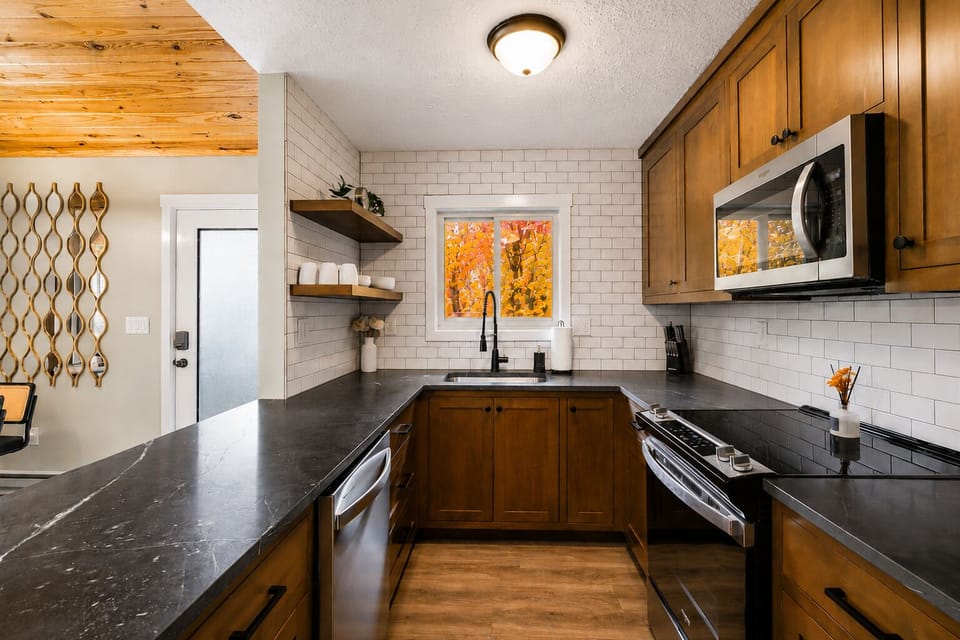 Modern kitchen with sleek counters & wood cabinets—perfect for cooking & sharing