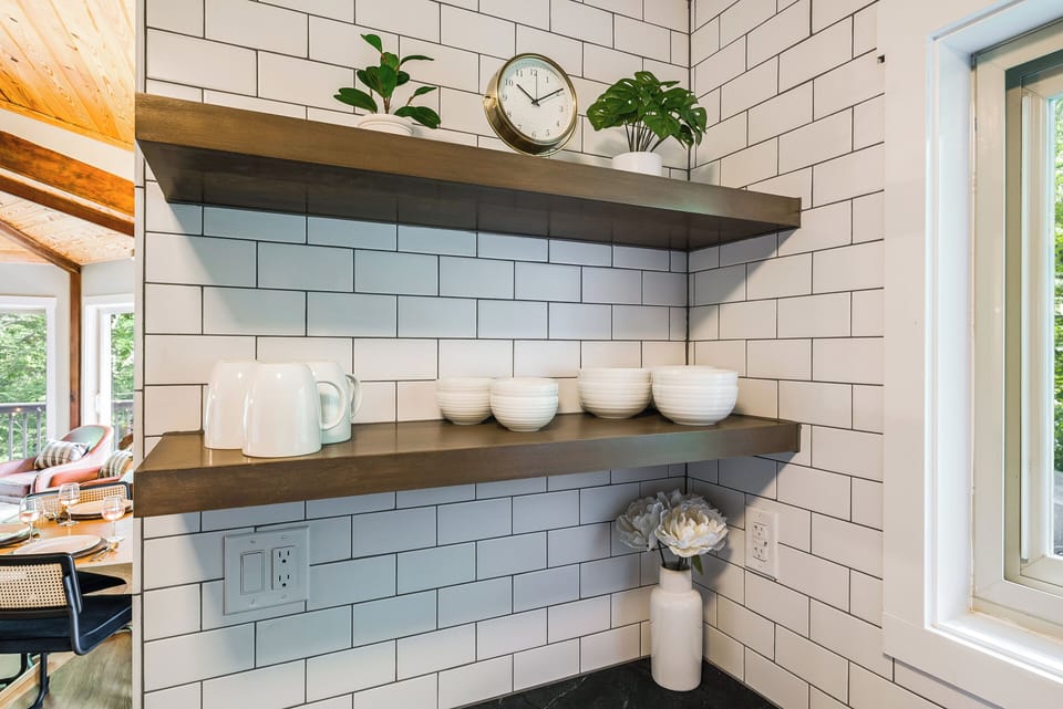 Subway tile & open shelving add style and function to this modern kitchen.