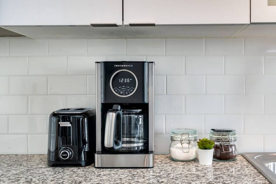 The coffee station is thoughtfully equipped with a variety of in-house consumables, including a selection of ground coffee, sweeteners, and creamers to suit every taste.