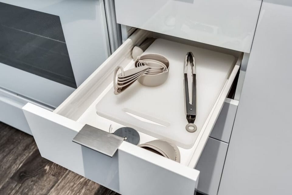 Kitchen utensils with measuring cups, Chopping board, and pizza cutter