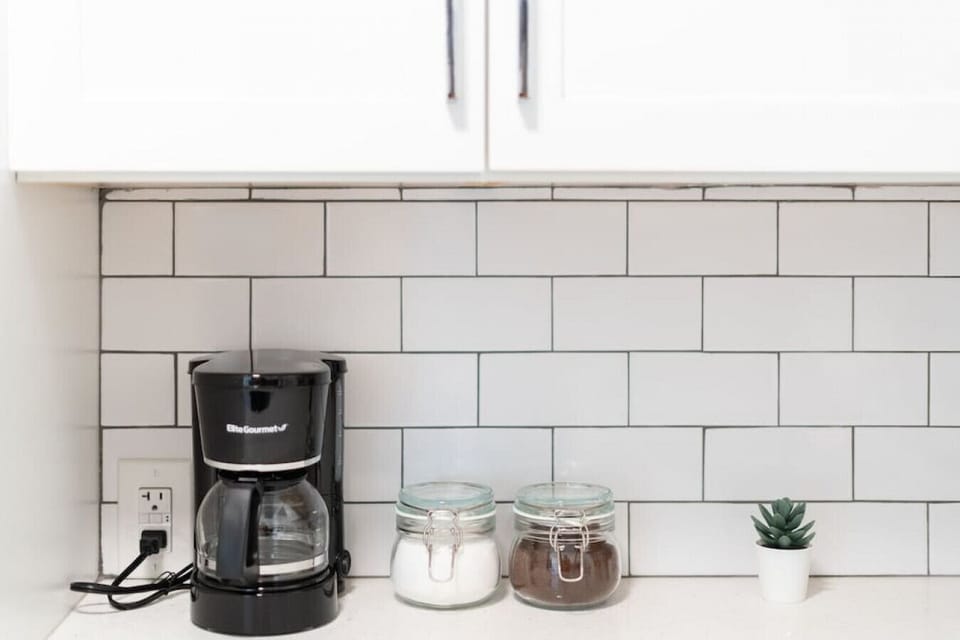 The coffee station is thoughtfully equipped with a variety of in-house consumables, including a selection of ground coffee, sweeteners, and creamers to suit every taste.