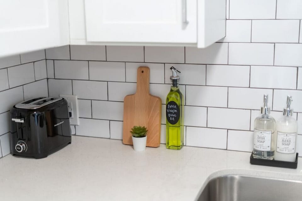 Kitchen cabinets stocked with cooking wares, glassware and silverwares, ideal for mixing up your favorite meals and drinks during your stay.