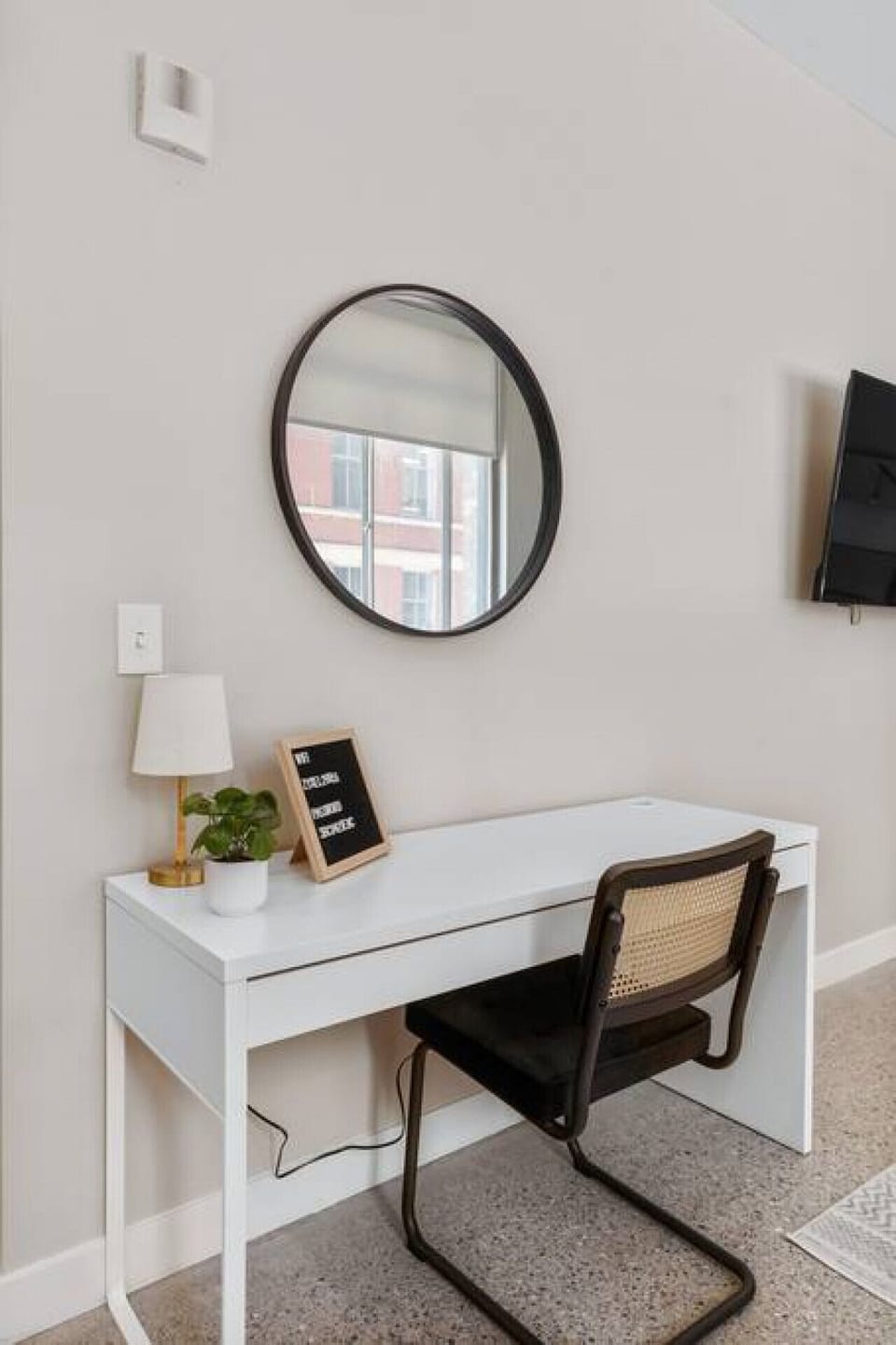This cozy workspace with warm lighting, and a creative wall display, perfect for productivity.