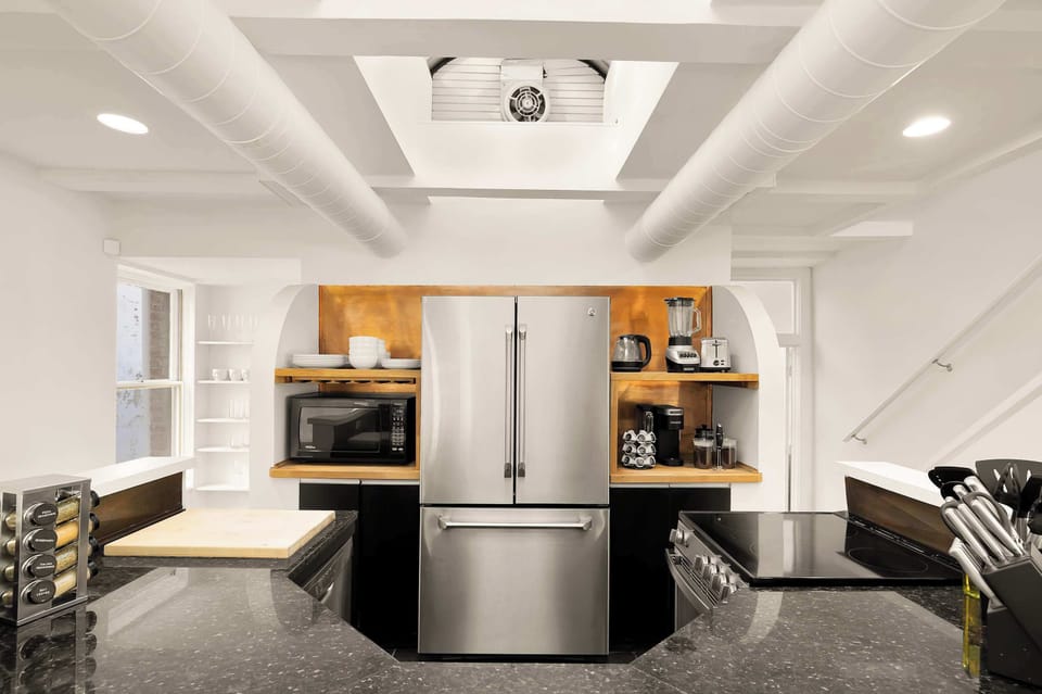 Cook like a pro in this fully stocked kitchen, blending modern convenience with the storied legacy of a building that once perfected precision and care