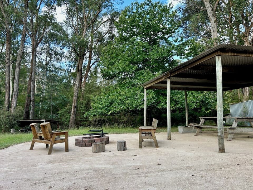 Outdoor dining and fire pit area with the sounds of the river close by.