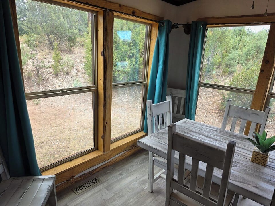 Open living, dining, and kitchen area with a farmhouse table seating six.