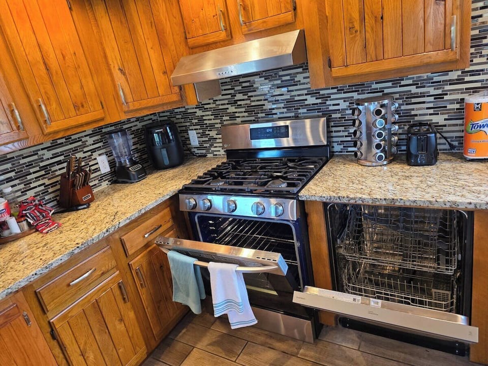 Kitchen sink window looks out over the trees, with a dish rack and views of the